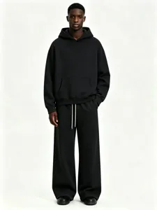 Close-up detail of the black fleece hoodie and sweatpants set, showing fabric texture and fit.