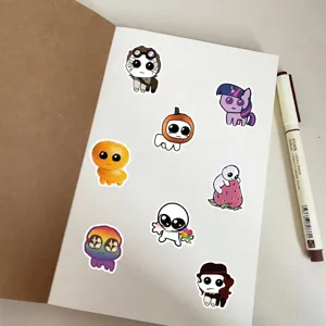 Detailed view of cute cartoon TBH creature stickers set on a notebook page for journaling.