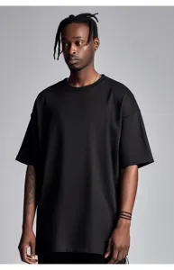 Close-up detail of the solid black heavy cotton t-shirt featuring a tight crew neck style.