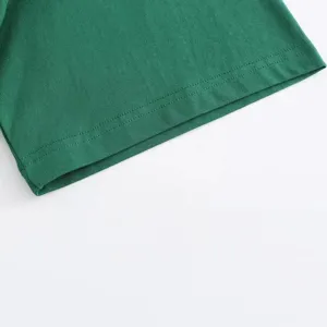 Close-up detail of heavyweight green short sleeve t-shirt hem showing neat stitching.