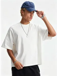 Detail shot of the white oversized dropped shoulder t-shirt showing the fit and styling.