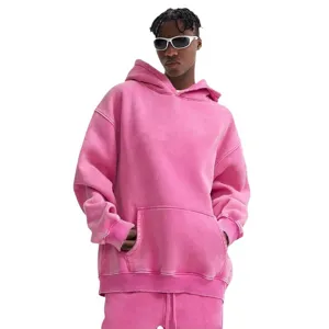 Detailed view of the heavy vintage washed men hoodie in pink, cozy fleece lined lifestyle.