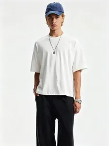 Detailed close-up view of the oversized dropped-shoulder short-sleeve tee in pure white.