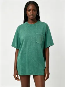 Detailed close-up view of a vintage washed green cotton pocket t-shirt fabric texture.