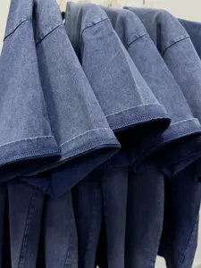 Close-up view of heavy acid wash vintage short sleeve t-shirt sleeve and fabric detail.