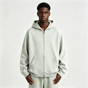 Detail view of the heavy cotton zip-up hoodie in light grey, showing soft texture and fit.