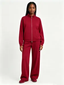 Burgundy zip-up stand collar sweatshirt and wide-leg trousers tracksuit detail view.