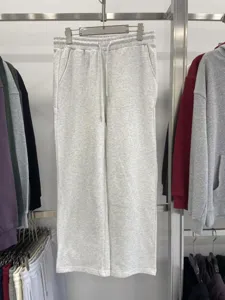 Casual grey sweatpants detail view, featuring comfortable heavy terry fabric and loose fit.