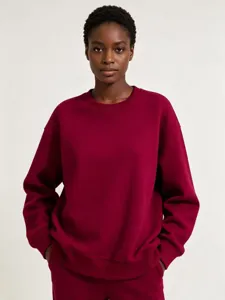 Detailed view of a thick fleece crewneck sweatshirt, solid color loose fit pullover top.