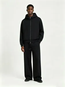 Detailed view of the heavy black zip-up hoodie and matching pants set with clean stitching.