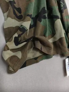 Detail shot of classic woodland camouflage long sleeve cotton t-shirt fabric and hem.