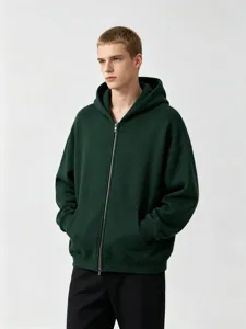 Close-up detail of the dark green heavy zip hoodie featuring metal hardware and soft fabric texture.