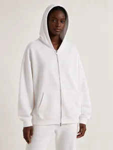 Detailed view of the heavy loop zip-up hoodie featuring clean white fabric and smooth metal zipper.