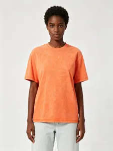 Vintage acid washed orange cotton t-shirt detail showing loose drop shoulder design and texture.