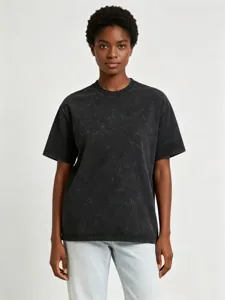 Close-up detail of the vintage acid-wash dark grey short sleeve t-shirt fit on model.
