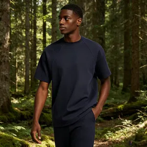 Detailed view of the dark navy blue short sleeve t-shirt in natural forest background.