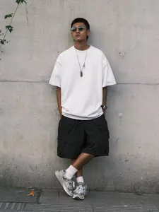 Detailed view of the oversized drop-shoulder short sleeve tee in an urban street style.