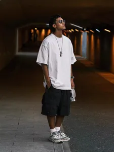 Detail view of heavy drop-shoulder short-sleeve t-shirt in white, street style fashion.