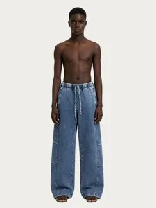 Detailed view of casual washed blue denim pants featuring a comfortable drawstring waist.