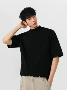 Close-up detail of mens black mock neck loose short sleeve t-shirt casual streetwear style.