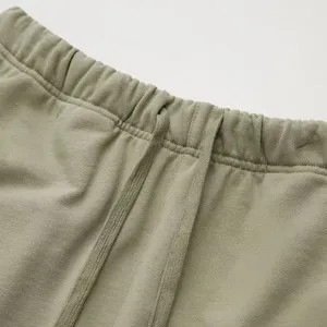 Close-up detail of casual sweatpants waistband with drawstring, showing soft fabric texture.