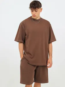 Close-up of the distressed brown washed cotton short-sleeve t-shirt and shorts set.