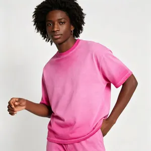 Detail view of men's pink acid wash cotton t-shirt showing soft texture and drop shoulder.
