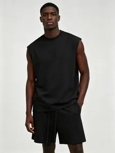 Detail shot of men black sleeveless tank top and shorts fitness set, comfortable and stylish streetwear.