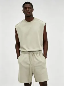Close-up view of the minimalist sleeveless crewneck tank top and matching drawstring shorts.