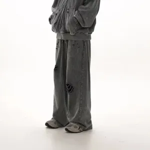 Distressed grey fleece sweatpants detail, casual loose wide-leg fit, American streetwear style.