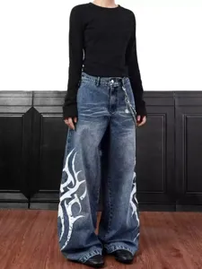 Trendy streetwear straight leg denim jeans with cool tribal prints and metal chain accessory.