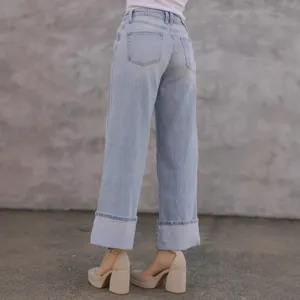 Light blue washed wide leg cuffed jeans for women, mid waist casual denim trousers detail.
