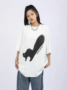 Oversized white t-shirt detail featuring a unique black cat graphic and artistic print design.