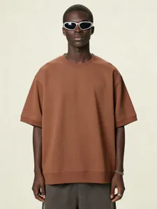 Detailed shot of brown french terry short sleeve tee with dropped shoulders and ribbed hem.