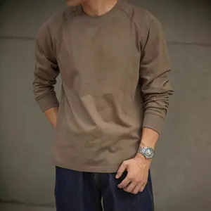 Close-up detail of the brown cotton raglan long-sleeve t-shirt with classic neckline.