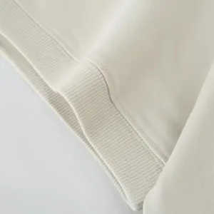 Close-up detail of soft fleece fabric with ribbed hem and neat stitching for apparel.