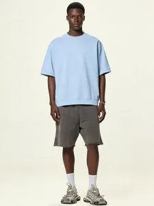 Detailed shot of a light blue oversized drop-shoulder loopback t-shirt with ribbed hem.