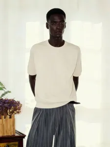 Detail shot of the loose french terry short-sleeve t-shirt with ribbed hem in off-white.