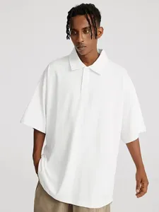 Men's solid white oversized short sleeve polo shirt detail view, classic lapel design.