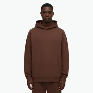 Detail view of the heavy loopback brown hoodie featuring cozy hood and front pocket.