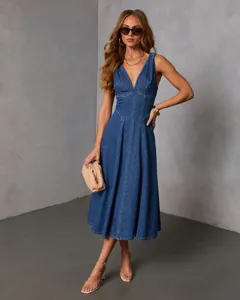 Detailed view of sexy V-neck denim slip dress featuring paneled stitching and flare hem.