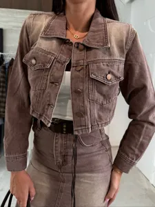 Brown denim jacket and skirt detail, casual autumn outfit with metal buttons and pockets.