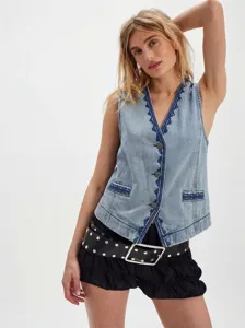 Detailed view of the stylish blue denim vest featuring elegant dark embroidery and buttons.