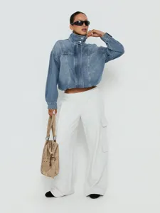 Vintage gewassen denim damesjack met opstaande kraag lange mouwen en losse pasvorm.