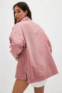 Casual pink denim jacket for women with side slits and practical pockets, back view.