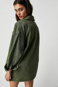 Detail view of the stylish green denim jacket, showing textured fabric and casual oversized fit.