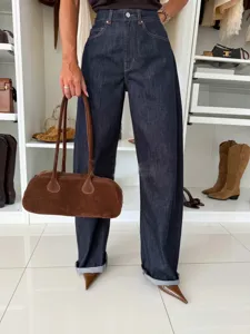 Detail view of stylish dark wash high-waisted wide leg denim jeans, comfortable fit.