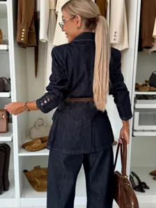 Detailed view of a dark denim suit with jacket and straight pants, stylish autumn outfit.