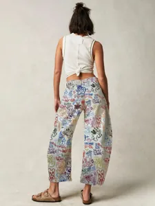 Women's mid-rise loose straight denim jeans featuring vibrant all-over graffiti and cartoon prints.