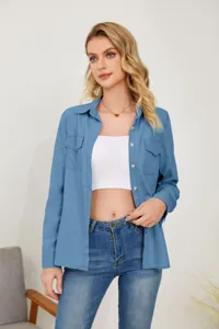 Detail shot of women's blue long-sleeve denim shirt, casual lapel single-breasted top.